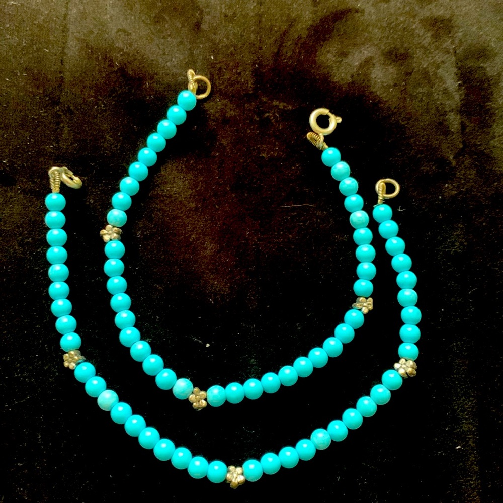 2 Turquoise Beaded Bracelets with silver flowers.